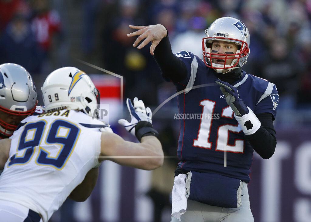 Charles Krupa New England Patriots quarterback Tom Brady (12) passes under pressure from Los Angeles Chargers defensive end Joey Bosa (99) during the first half of an NFL divisional playoff football game, Sunday, Jan. 13, 2019, in Foxborough, Mass. (AP Photo/Charles Krupa)