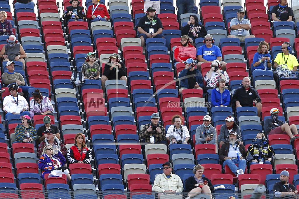 Ralph Freso A limited number of fans social distance in the grandstands as they watch the NASCAR Xfinity Series auto race at Phoenix Raceway, Saturday, Nov. 7, 2020, in Avondale, Ariz. (AP Photo/Ralph Freso)