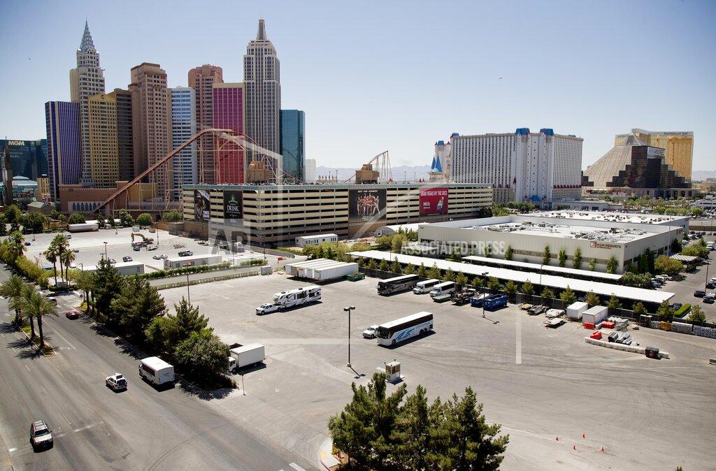 Julie Jacobson FILE - In this June 18, 2013, file photo, the New York-New York hotel-casino, left, is seen from the Monte Carlo parking garage west of The Strip in Las Vegas. MGM Resorts International says it'll begin charging parking fees again at events and its Las Vegas Strip resorts. The move marks the end of free parking that lingered after pandemic-related casino shutdowns. In a statement on Tuesday, May 11, 2021, the company cited signs of economic recovery and increasing numbers of guests. (AP Photo/Julie Jacobson, File)