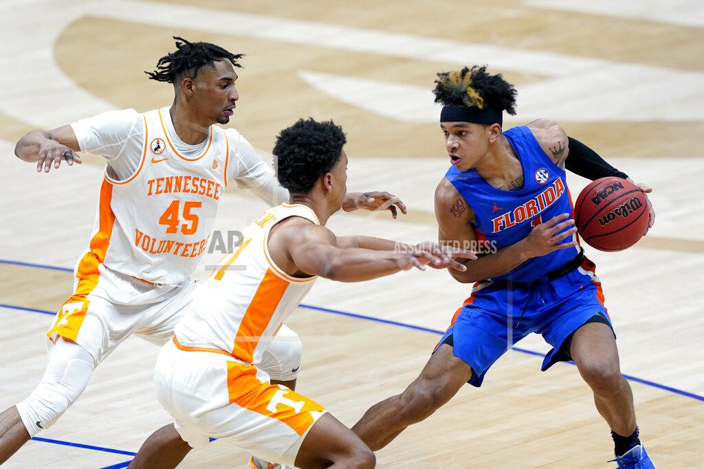 Mark Humphrey Florida's Tre Mann (1) is defended by Tennessee's Keon Johnson (45) and Jaden Springer (11) in the first half of an NCAA college basketball game in the Southeastern Conference Tournament Friday, March 12, 2021, in Nashville, Tenn. (AP Photo/Mark Humphrey)