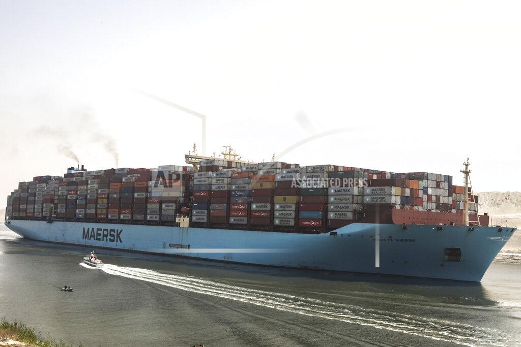Mohamed Elshahed A container ship passes through Suez Canal, Egypt, Tuesday, April 6, 2021. The Suez Canal chief said that authorities are negotiating a financial settlement with the owners of a massive vessel that blocked the crucial waterway for nearly a week. (AP Photo/Mohamed Elshahed)