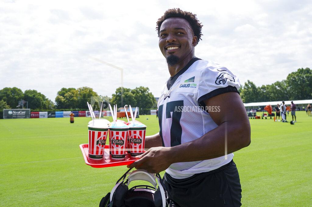 Chris Szagola Philadelphia Eagles' Nakobe Dean walks back to the locker room with a trey of Italian water ice during practice at the NFL football team's training camp, Wednesday, July 27, 2022, in Philadelphia. (AP Photo/Chris Szagola)