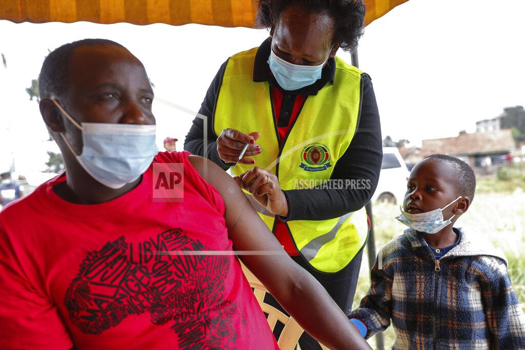 Brian Inganga A Kenyan man receives a dose of AstraZeneca coronavirus vaccine donated by Britain, as his son watches, at the Makongeni Estate in Nairobi, Kenya Saturday, Aug. 14, 2021. In late June, the international system for sharing coronavirus vaccines sent about 530,000 doses to Britain – more than double the amount sent that month to the entire continent of Africa. It was the latest example of how a system that was supposed to guarantee low and middle-income countries vaccines is failing, leaving them at the mercy of haphazard donations from rich countries.(AP Photo/Brian Inganga)