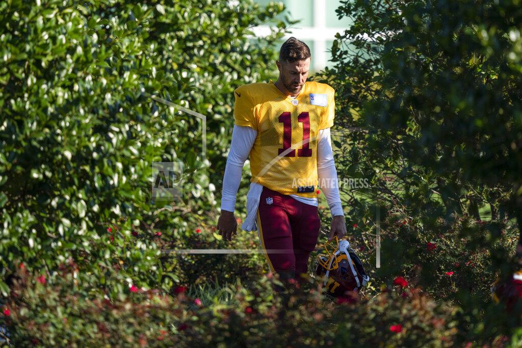Washington quarterback Alex Smith (11) walks to practice at the team's NFL football training facility, Tuesday, Aug. 18, 2020, in Ashburn, Va. (AP Photo/Alex Brandon)