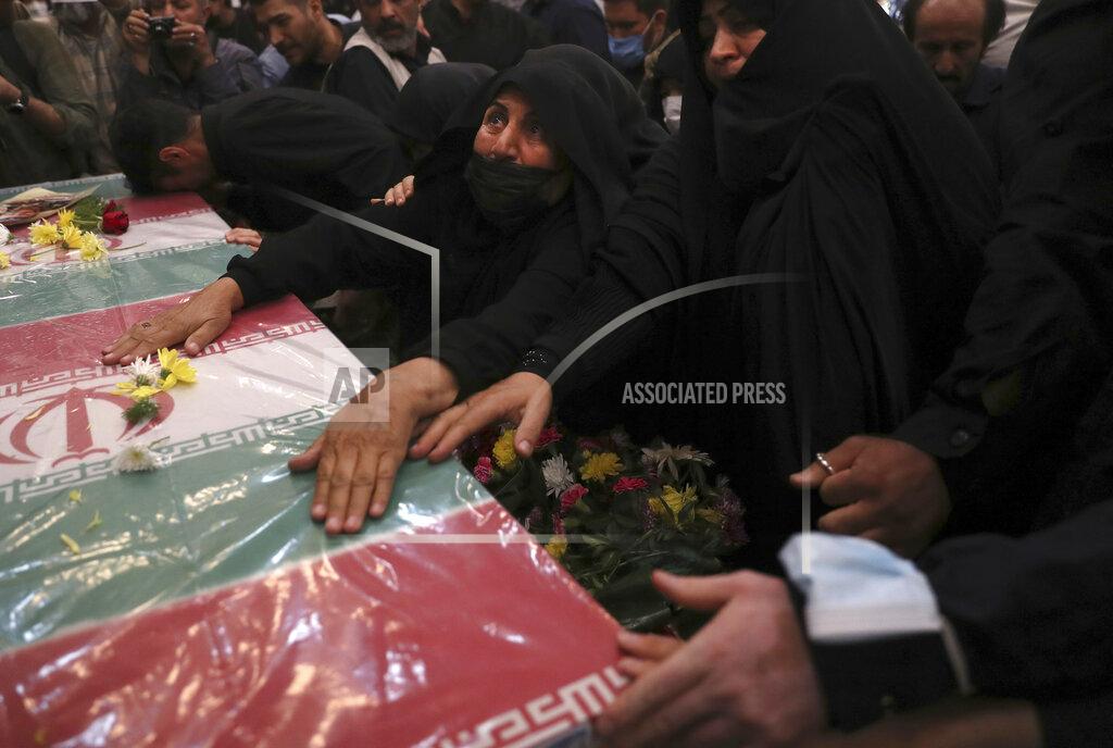 Vahid Salemi Relatives mourn over the flag draped coffin of Iran's Revolutionary Guard Col. Hassan Sayyad Khodaei who was killed on Sunday, in his funeral ceremony in Tehran, Iran, Tuesday, May 24, 2022. Iran's hard-line President Ebrahim Raisi vowed revenge on Monday over the killing of Sayyad Khodaei who was shot at his car by two assailants outside his home in Tehran, a still-mysterious attack on the country's powerful paramilitary force. (AP Photo/Vahid Salemi)