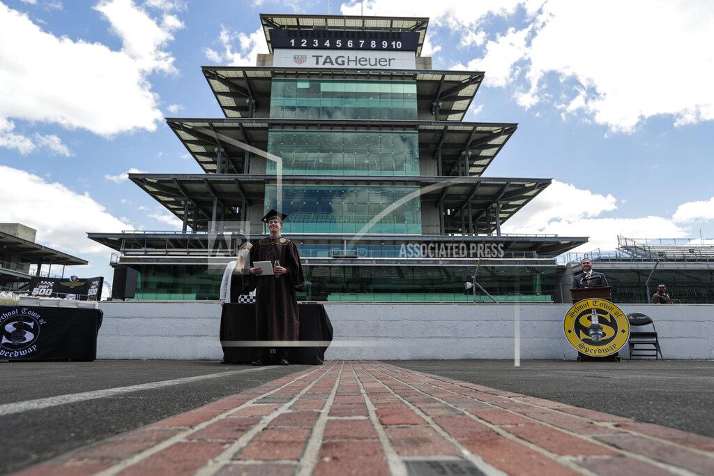 Michael Conroy Eli Collins receives his Speedway High School diploma during a ceremony on the start/finish line at the Indianapolis Motor Speedway in Indianapolis, Saturday, May 30, 2020. The ceremony was held at the track to allow for social distancing requirements due to the COVID-19 pandemic. (AP Photo/Michael Conroy)