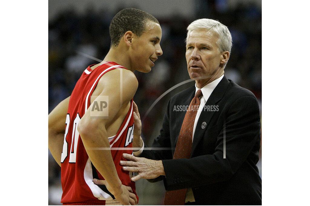 Chuck Burton FILE - Davidson's head coach Bob McKillop, right, speaks with Stephen Curry during the first half of a first round NCAA Midwest Regional basketball game against Gonzaga in Raleigh, N.C., Friday, March 21, 2008. Longtime Davidson coach Bob McKillop is retiring, ending a run that included coaching NBA star Stephen Curry with the Wildcats and ranking among the Division I men’s basketball’s winningest active coaches. McKillop announced his retirement Friday, June 17, 2022, at a campus news conference, effective at the end of the month. (AP Photo/Chuck Burton, File)