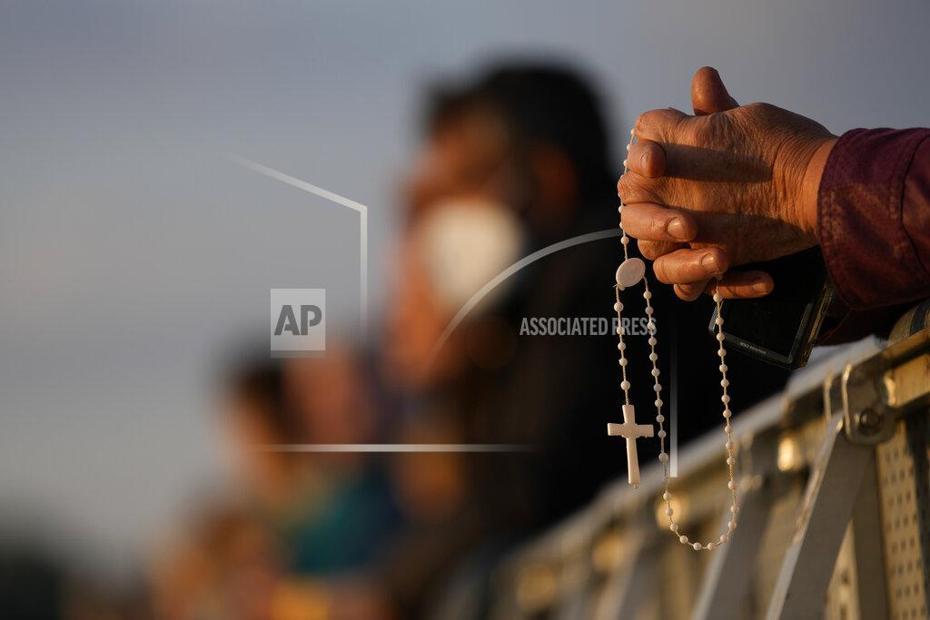 Petr David Josek A man prays as he waits for Pope Francis arrival in the esplanade of the National Shrine in Sastin, Slovakia, Wednesday, Sept. 15, 2021. Pope Francis is to hold an open air mass in Sastin near the Slovakian capital on Wednesday, the site of an annual pilgrimage each September 15 to venerate Slovakia's patron, Our Lady of Sorrows. (AP Photo/Petr David Josek)