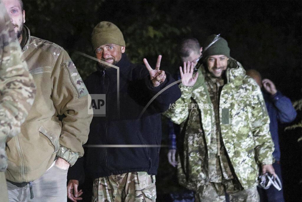 Uncredited In this photo provided by the Ukrainian Security service Press Office, Ukrainian soldiers, who were released in a prisoner exchange between Russia and Ukraine, smile close to Chernihiv, Ukraine, late Wednesday, Sept. 21, 2022. Ukraine announced a high-profile prisoner swap early Thursday that culminated months of efforts to free many of the Ukrainian fighters who defended a steel plant in Mariupol during a long Russian siege. (Ukrainian Security service Press Office via AP)