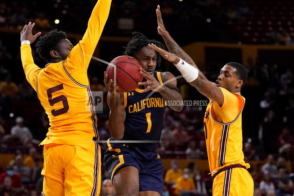 Matt York California guard Joel Brown (1) passes as Arizona State guard Jay Heath (5) defends during the first half of an NCAA college basketball game, Thursday, March 3, 2022, in Tempe, Ariz. (AP Photo/Matt York)