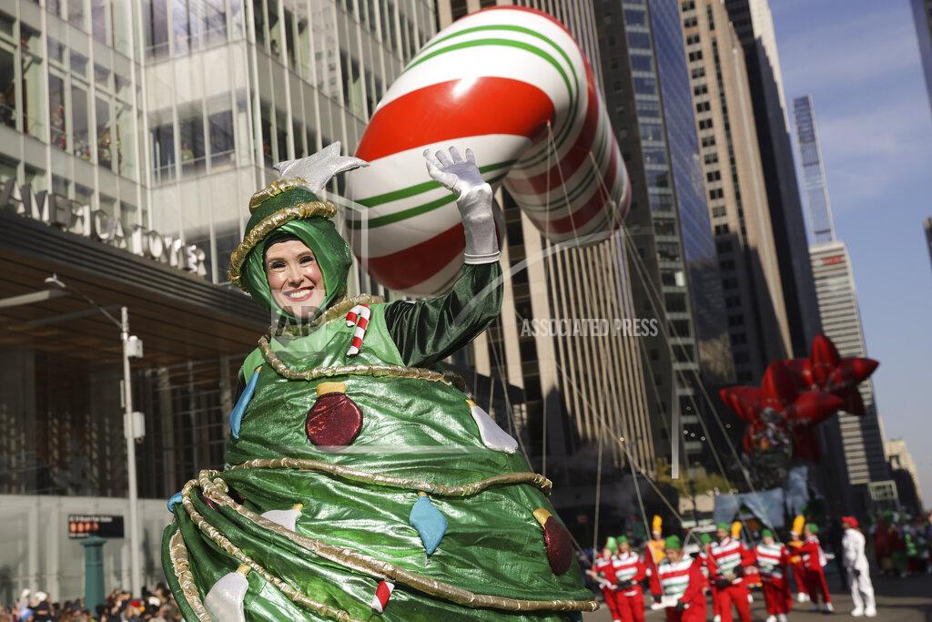 Jeenah Moon A parade performer in a Christmas Tree costume walks down Sixth Avenue during the Macy's Thanksgiving Day Parade, Thursday, Nov. 24, 2022, in New York. (AP Photo/Jeenah Moon)