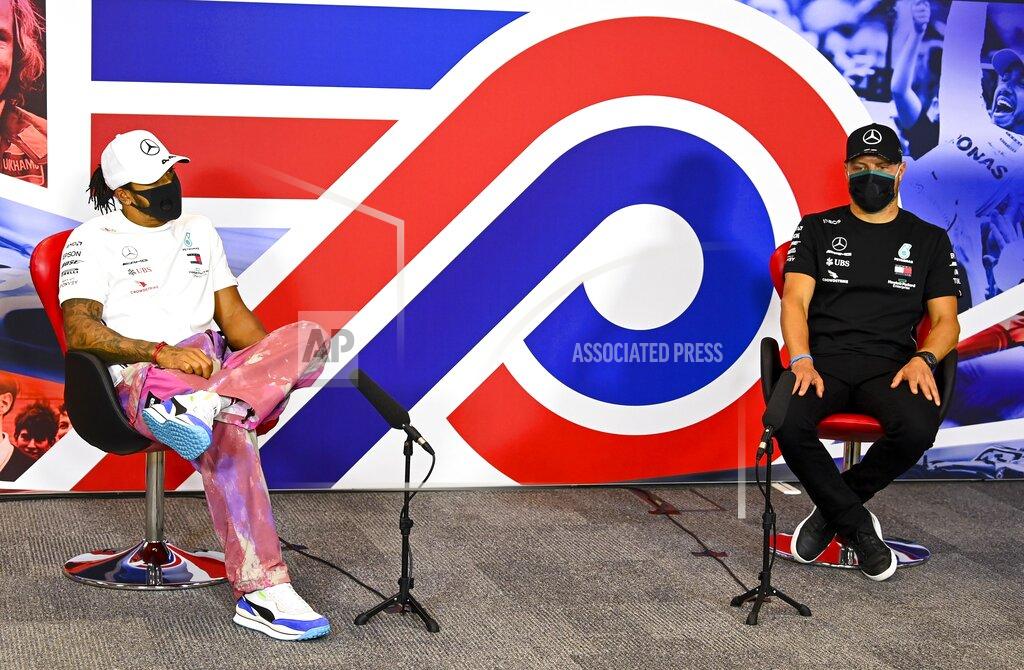 Mark Sutton Mercedes driver Lewis Hamilton of Britain and Mercedes driver Valtteri Bottas of Finland attend the press conference in the build-up to the 70th Anniversary Formula One Grand Prix at the Silverstone circuit, Silverstone, England, Thursday, Aug. 6, 2020.(Mark Sutton/Pool via AP)