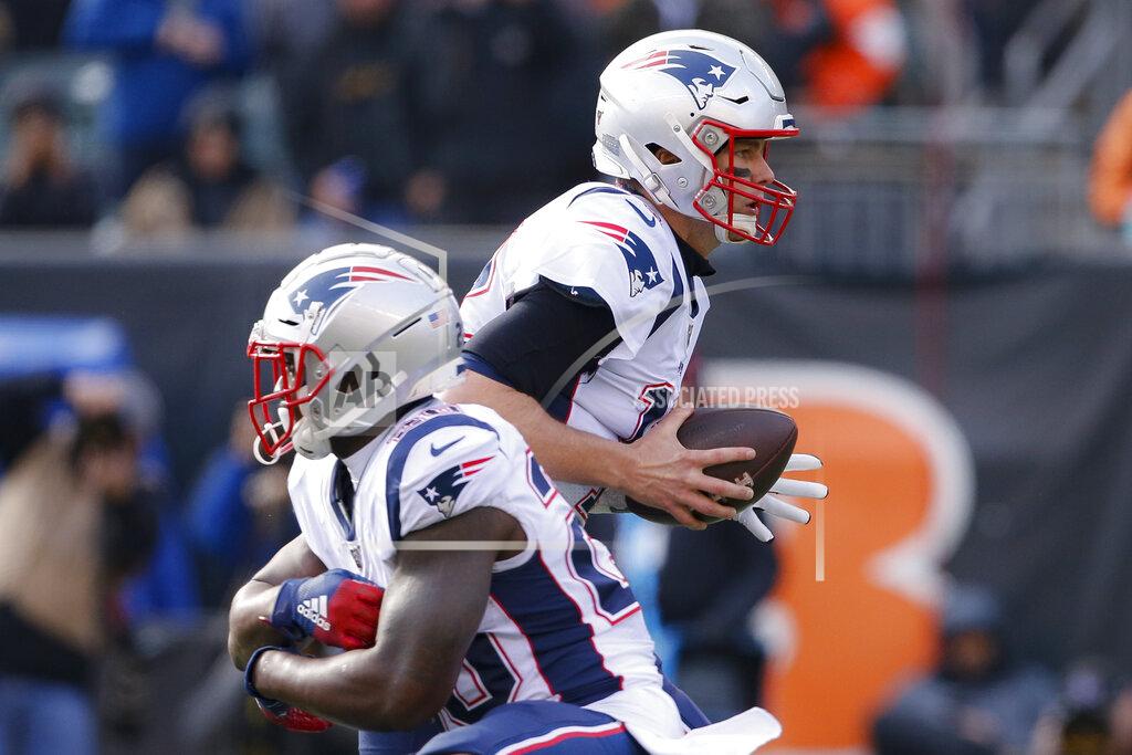 Gary Landers New England Patriots quarterback Tom Brady, right, fakes a handoff to running back James White, left, in the first half of an NFL football game against the Cincinnati Bengals, Sunday, Dec. 15, 2019, in Cincinnati. (AP Photo/Gary Landers)