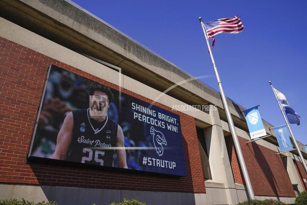 Seth Wenig A billboard celebrates the men's basketball team at Saint Peter's University in Jersey City, N.J., Monday, March 21, 2022. (AP Photo/Seth Wenig)