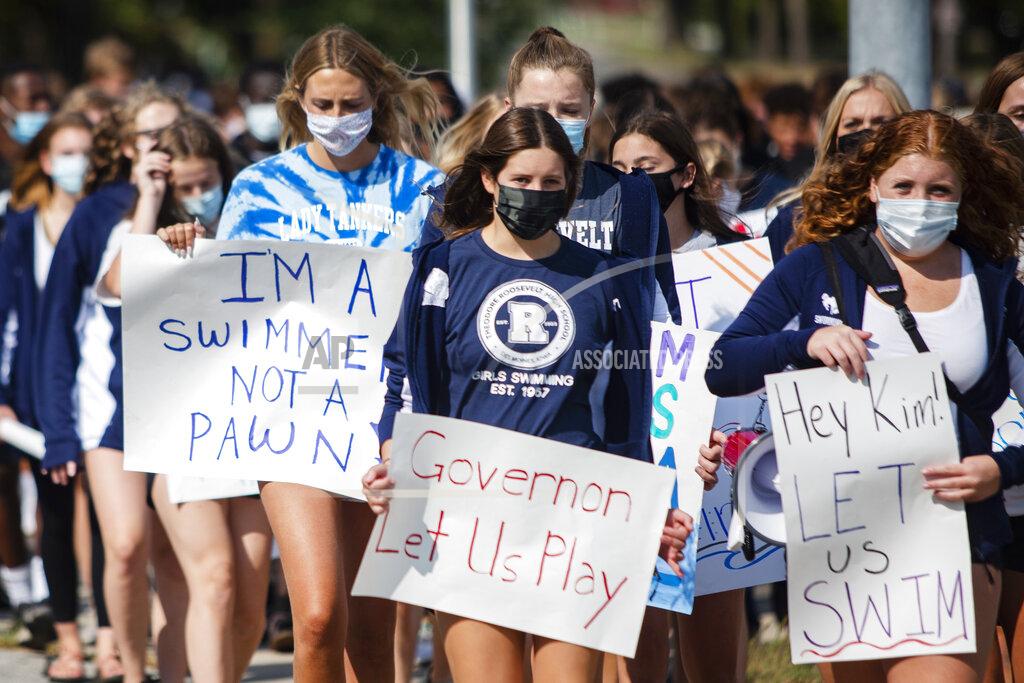 Olivia Sun Des Moines Public School students and supporters march from Roosevelt High School to the Governor's Mansion at Terrace Hill to protest the cancellation of fall and winter extracurriculars on Sept. 7, 2020, in Des Moines, Iowa. All in-person activities were suspended this month as the district's classroom instruction remains virtual. (Olivia Sun/The Des Moines Register via AP)