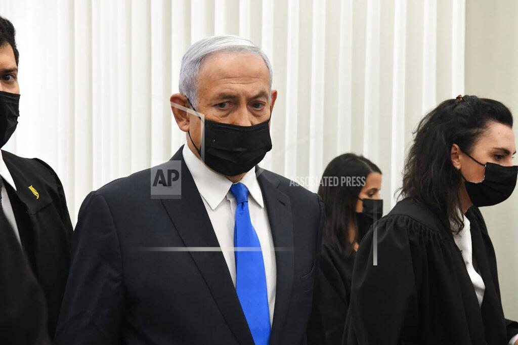 Reuven Castro Israeli Prime Minister Benjamin Netanyahu stands at a hearing at the district court in Jerusalem, Monday, Feb. 8, 2021. Netanyahu appeared in a Jerusalem courtroom Monday to respond formally to corruption charges just weeks before national elections in which he hopes to extend his 12-year rule. (AP Photo/Reuven Castro, Pool)