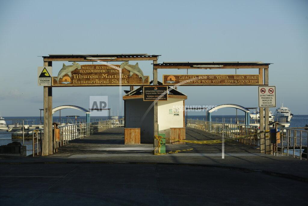 Adrian Vasquez This May 2, 2020 photo shows a pier usually swarming with arriving and departing tourists, in San Cristobal, Galapagos Islands, Ecuador. For seven weeks now due to the new coronavirus pandemic, not a single tourist has arrived at the UNESCO World Heritage site that inspired Charles Darwin. (AP Photo/Adrian Vasquez)