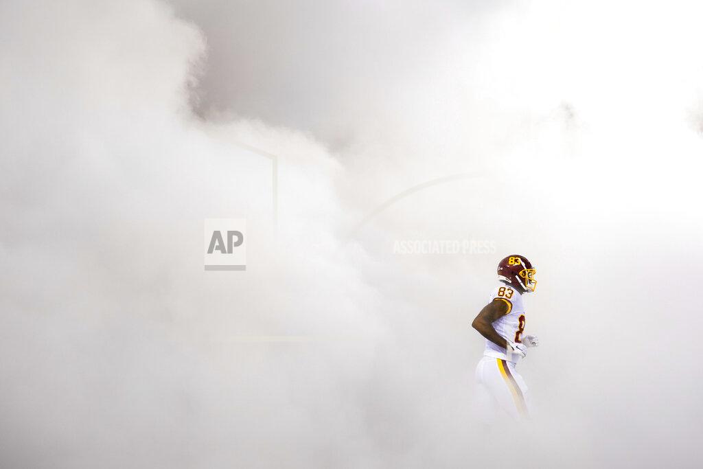 Patrick Semansky Washington Football Team tight end Ricky Seals-Jones (83) runs through a cloud of smoke as he takes the field during team introductions before the start of first half of an NFL football game against the New York Giants, Thursday, Sept. 16, 2021, in Landover, Md. (AP Photo/Patrick Semansky)