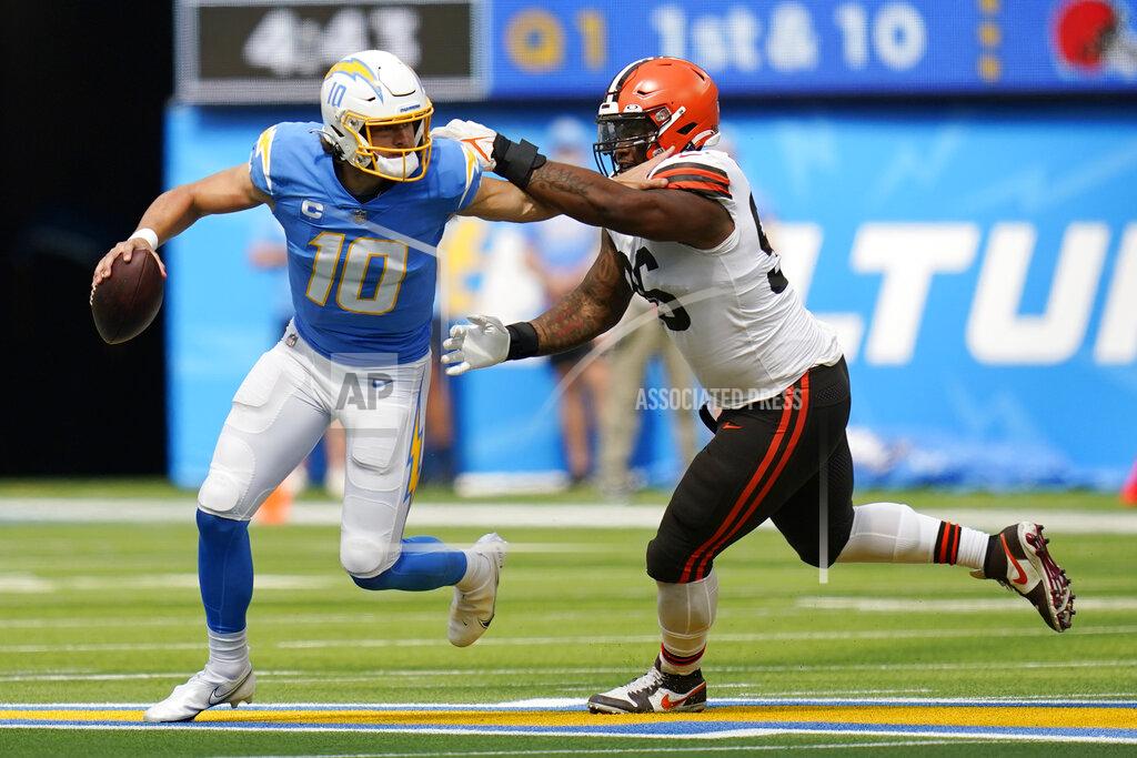 Gregory Bull Los Angeles Chargers quarterback Justin Herbert (10) is pressured by Cleveland Browns defensive tackle Jordan Elliott during the first half of an NFL football game Sunday, Oct. 10, 2021, in Inglewood, Calif. (AP Photo/Gregory Bull)