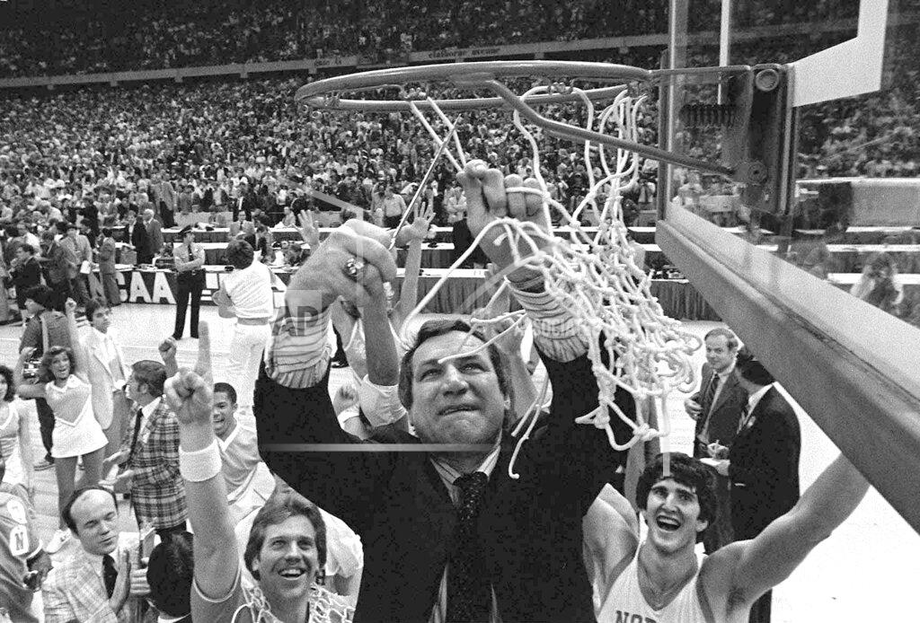 FILE - In this March 29, 1982, file photo, North Carolina basketball coach Dean Smith cuts the net as happy players and fans cheer after the Tar Heels defeated Georgetown for the NCAA college basketball Final Four championship, in New Orleans. The NCAA championship was the only thing missing from Smith's trophy case in an otherwise brilliant career that includes one of the best records in coaching — 468-145 over 21 years in Chapel Hill — an Olympic gold medal and acknowledgment by peers of his basketball greatness. (AP Photo/Pete Leabo, File)