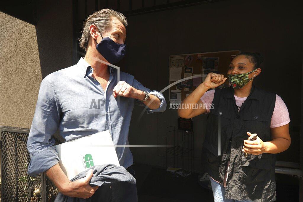 Genaro Molina California Gov. Gavin Newsom prepares to connect elbows with Candace O'Connor, owner of Brimberry Barber and Beauty Salon, in Leimert Park in Los Angeles after she shared her thoughts on running a business in the time of COVID-19 and the recent protests in the city Wednesday, June 3, 2020. (Genaro Molina/Los Angeles Times via AP, Pool)