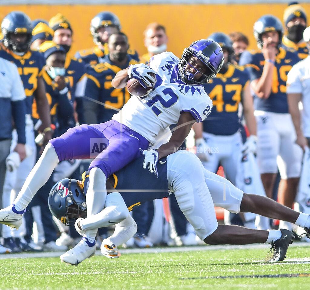 William Wotring TCU wide receiver Blair Conwright (22) makes a catch and is tackled by West Virginia safety Jake Long (22) during the second half of an NCAA college football game on Saturday, Nov. 14, 2020, in Morgantown, W.Va. (William Wotring/The Dominion-Post via AP)