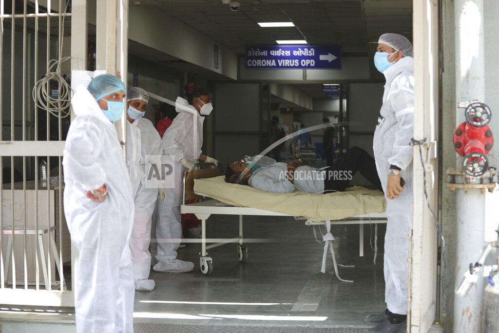 Ajit Solanki FILE - In this April 15, 2021, file photo, health workers carry a patient into a dedicated COVID-19 hospital in Ahmedabad, India. The picture is still grim in parts of Europe and Asia as variants of the virus fuel an increase in new cases and the worldwide death toll closes in on 3 million. (AP Photo/Ajit Solanki, File)