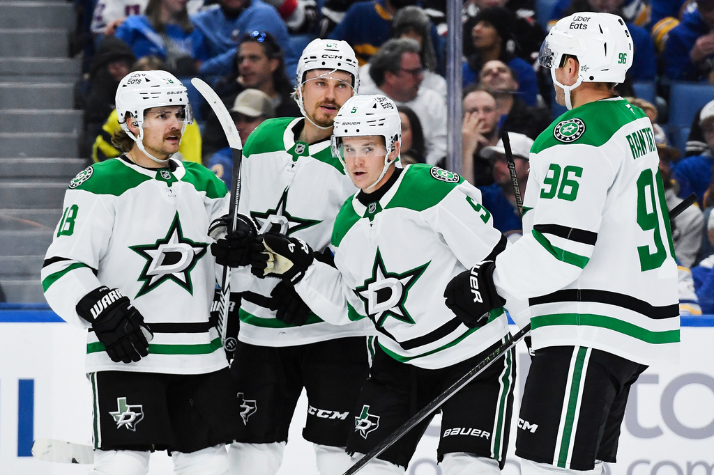 Dallas Stars center Sam Steel, left, celebrates with center Roope Hintz, second from left, defenseman Nils Lundkvist (5) and right wing Mikko Rantanen (96) after scoring during the second period of an NHL hockey game against the Buffalo Sabres, Thursday, Oct. 8, 2026, in Buffalo, N.Y. (AP Photo/Adrian Kraus)