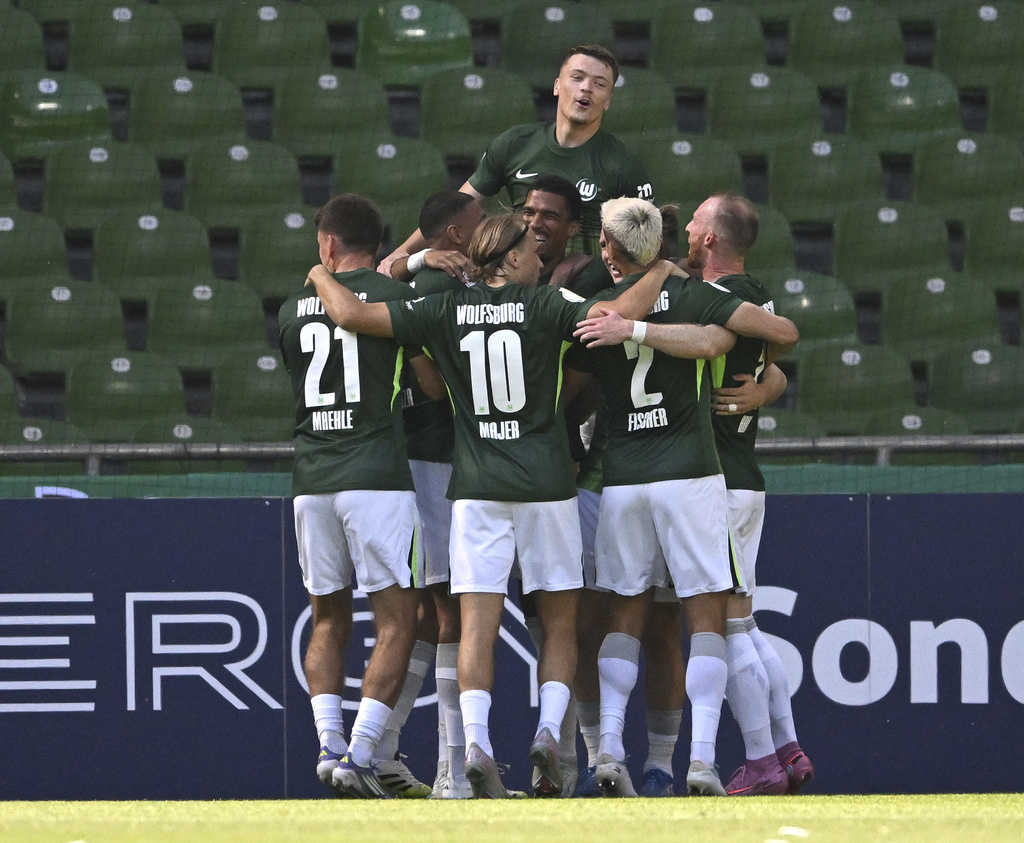 Wolfsburg's players celebrate the opening goal during the German soccer cup first round match between SV Hemelingen and VfL Wolfsburg in Bremen, Germany, Saturday, Aug 16, 2025. (Carmen Jaspersen/dpa via AP)