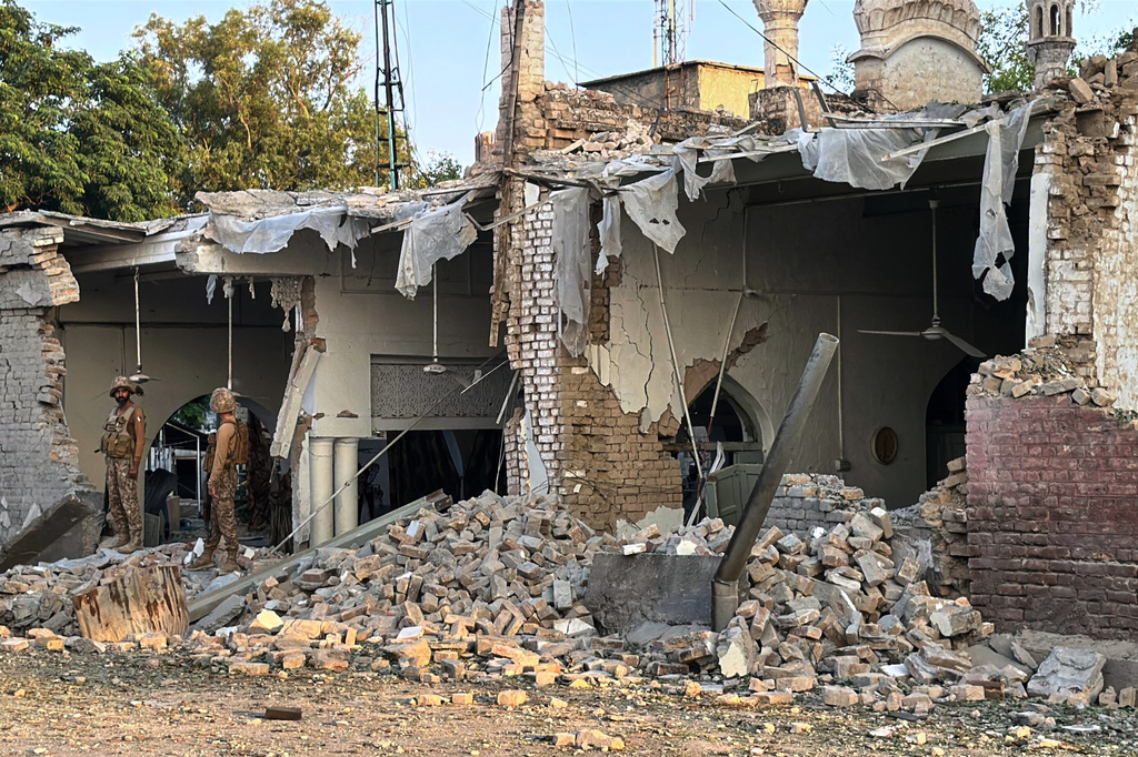 Army soldiers stand over the rubble at the site of a powerful bomb exploded at a mosque in Kohat, in northwestern Pakistan, Friday, Sept. 18, 2026. (AP Photo/Maaz Awan)
