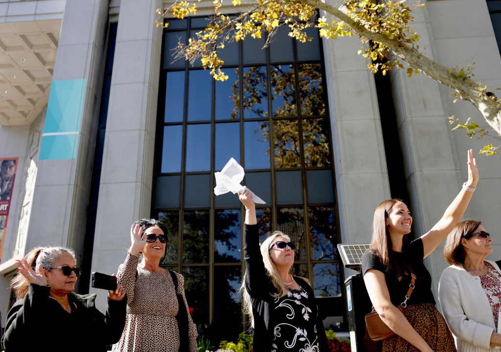 Patricia Knavel of Layton waves a white handkerchief as the processional drives by following the funeral service of President Russell M. Nelson of The Church of Jesus Christ of Latter-day Saints in Salt Lake City on Oct. 7, 2025. (Laura Seitz/The Deseret News via AP)