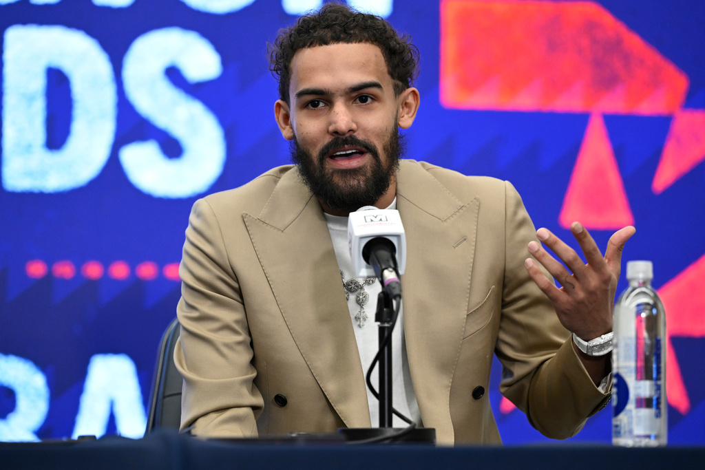 Washington Wizards newly acquired point guard Trae Young answers a question at news conference before an NBA basketball game against the New Orleans Pelicans, Friday, Jan. 9, 2026, in Washington. (AP Photo/John McDonnell)