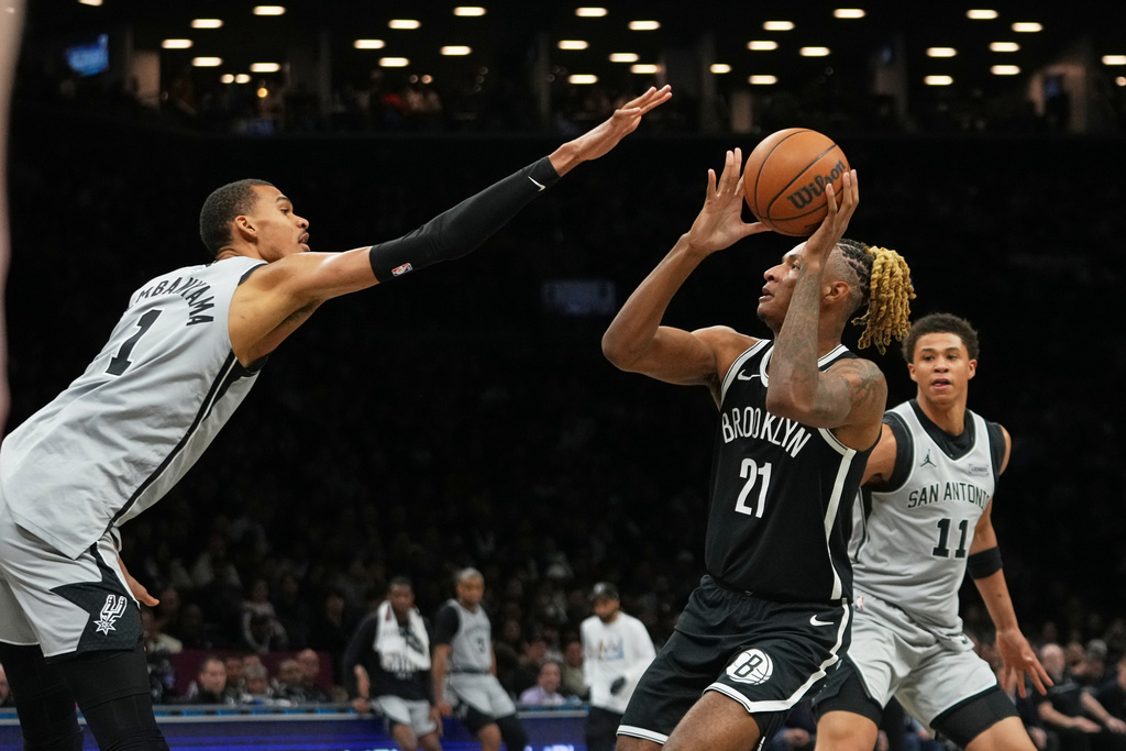 San Antonio Spurs' Victor Wembanyama, left, defends a shot by Brooklyn Nets' Noah Clowney (21) during the first half of an NBA basketball game Thursday, Feb. 26, 2026, in New York. (AP Photo/Frank Franklin II)