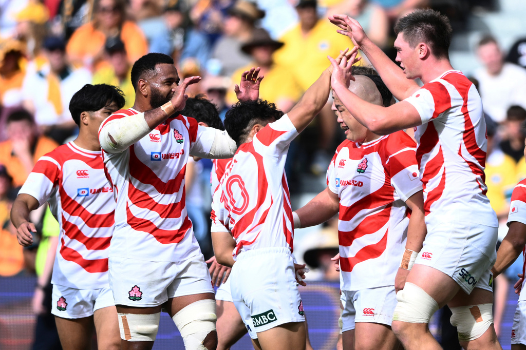 Japan's Harry Hockings, right, is congratulated by teammates after scoring a tryduring a rugby international between Japan and Australia in Townsville, Australia, Saturday, Aug.15, 2026. (Matt Taylor/AAPImage via AP)