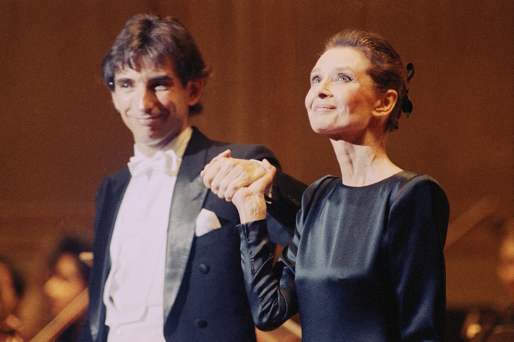 FILE - Audrey Hepburn, right, appears with New World Symphony's artistic advisor Michael Tilson Thomas at the Academy of Music in Philadelphia on March 19, 1990. (AP Photo/Bill Cramer, File)