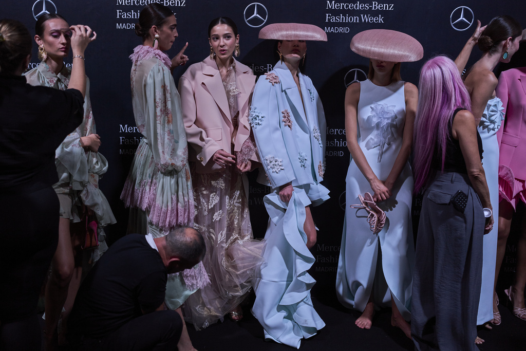 Models wear designs by Isabel Sanchis backstage during the brand's show at Fashion Week in Madrid, Spain, Friday, Sept. 19, 2025. (AP Photo/Manu Fernandez)