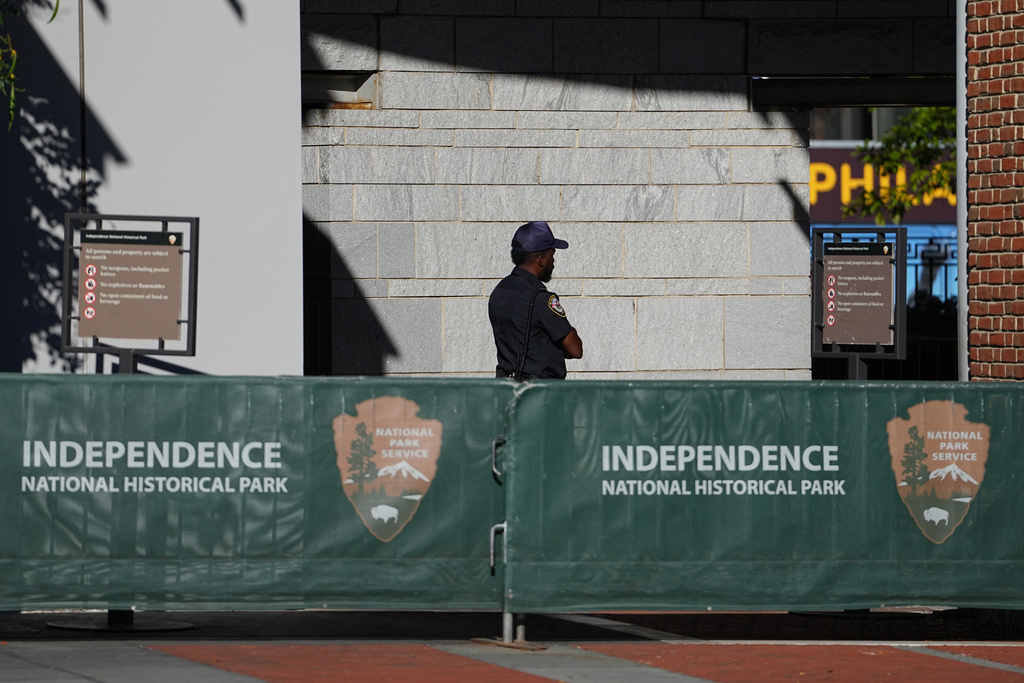 A guard stands at the entrance to The Liberty Bell center that is closed due to a government shutdown in Philadelphia, Wednesday,Oct. 1, 2025. (AP Photo/Matt Rourke)