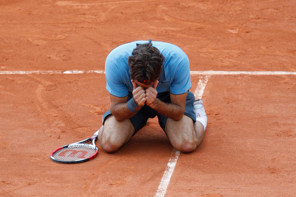 FILE - Switzerland's Roger Federer jubilates after defeating Sweden's Robin Soderling during their men's singles final match of the French Open tennis tournament at the Roland Garros stadium in Paris, June 7, 2009. (AP Photo/Christophe Ena, File)