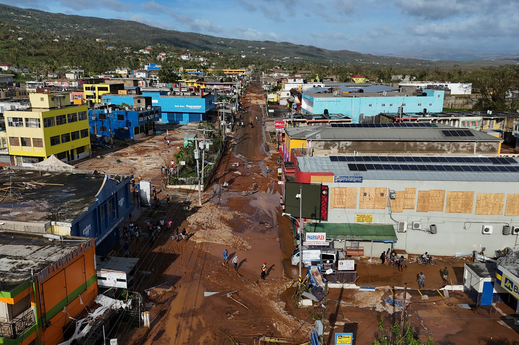 FILE - Residents walk through Santa Cruz, Jamaica, Oct. 29, 2025, after Hurricane Melissa passed. (AP Photo/Matias Delacroix, File)
