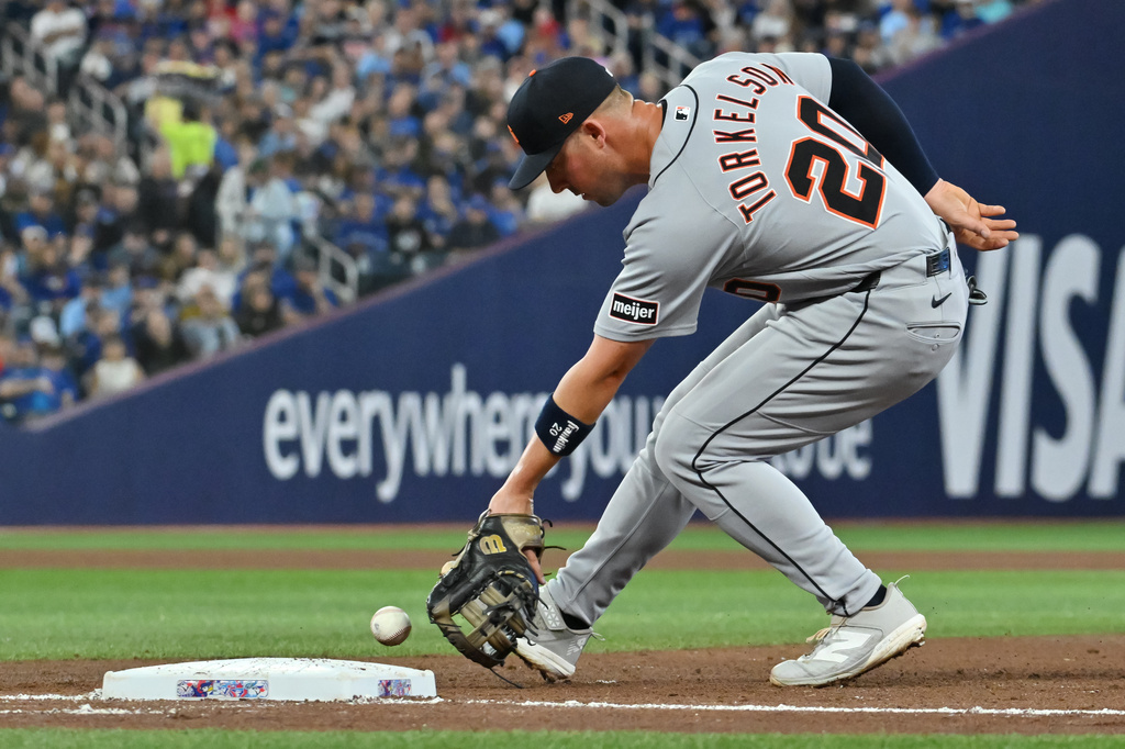 Detroit Tigers first baseman Spencer Torkelson (20) scoops up a ground ball off the bat of Toronto Blue Jays' Nathan Lukes for an out during fourth inning of a baseball game in Toronto, Tuesday, Sept. 15, 2026. (Jon Blacker/The Canadian Press via AP)