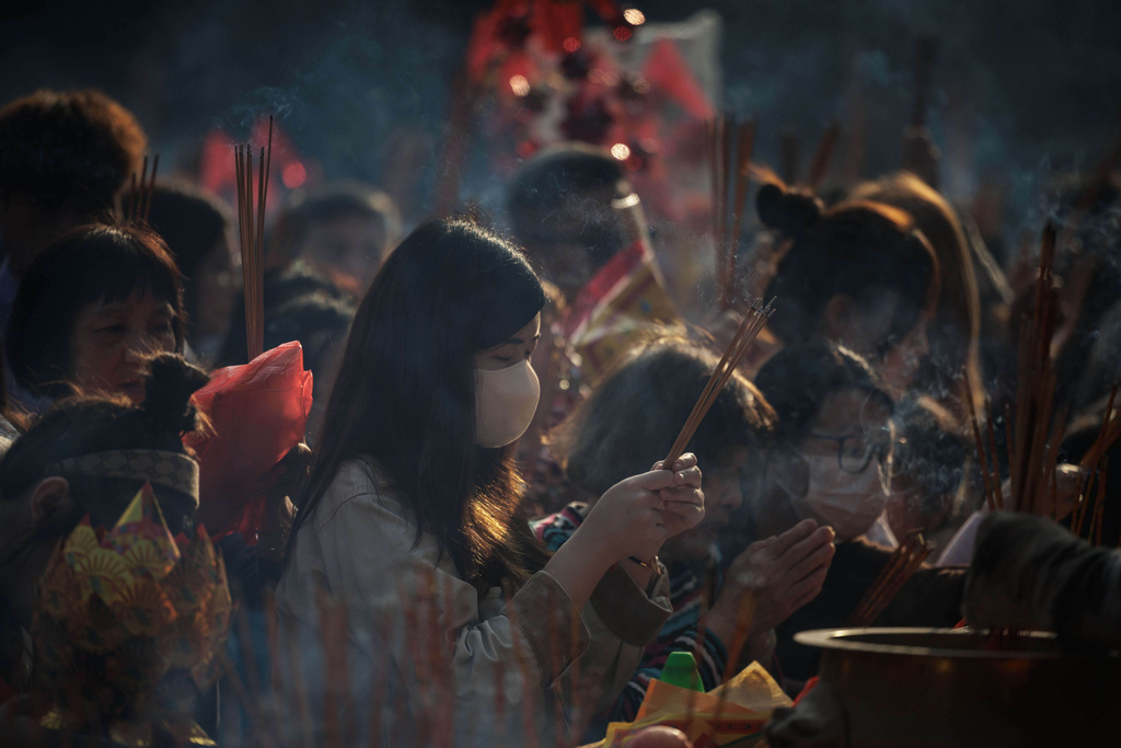 Worshippers hold incense sticks as they pray during Lunar New Year celebrations at Wong Tai Sin temple in Hong Kong, Feb. 18, 2026. (AP Photo/May James)
