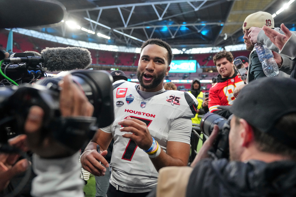 Houston Texans quarterback C.J. Stroud (7) smiles as he leaves the field after an NFL football game against Jacksonville Jaguars in London, Sunday, Oct. 18, 2026. (AP Photo/Kin Cheung)