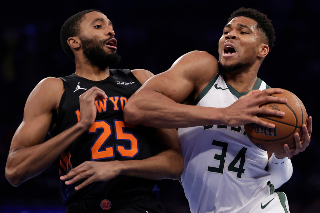 Milwaukee Bucks forward Giannis Antetokounmpo (34) drives past New York Knicks guard Mikal Bridges (25) during the first half of an NBA Cup basketball game Friday, Nov. 28, 2025, in New York. (AP Photo/Adam Hunger)