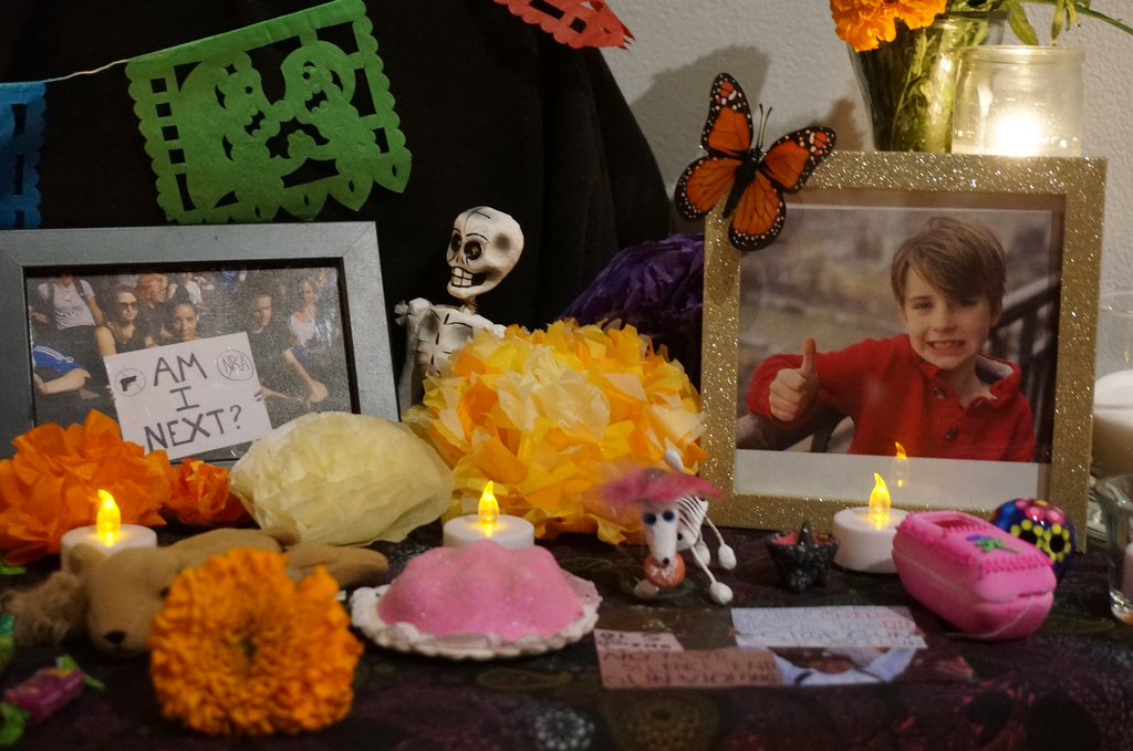 Photos commemorating the deadly shooting in August during Mass at Annunciation Catholic School in Minneapolis are part of an “ofrenda” marking Día de Muertos (Day of the Dead) at El Colegio High School in Minneapolis on Saturday, Nov. 1, 2025. (AP Photo/Giovanna Dell'Orto)