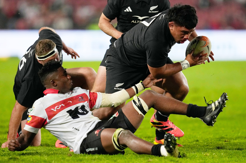 New Zealand's Ofa Tu'ungafasi, right, breaks away from Lions' Siba Mahashe during an international friendly rugby match between the Lions and New Zealand in Johannesburg, South Africa, Tuesday, Aug. 25, 2026. (AP Photo/Themba Hadebe)