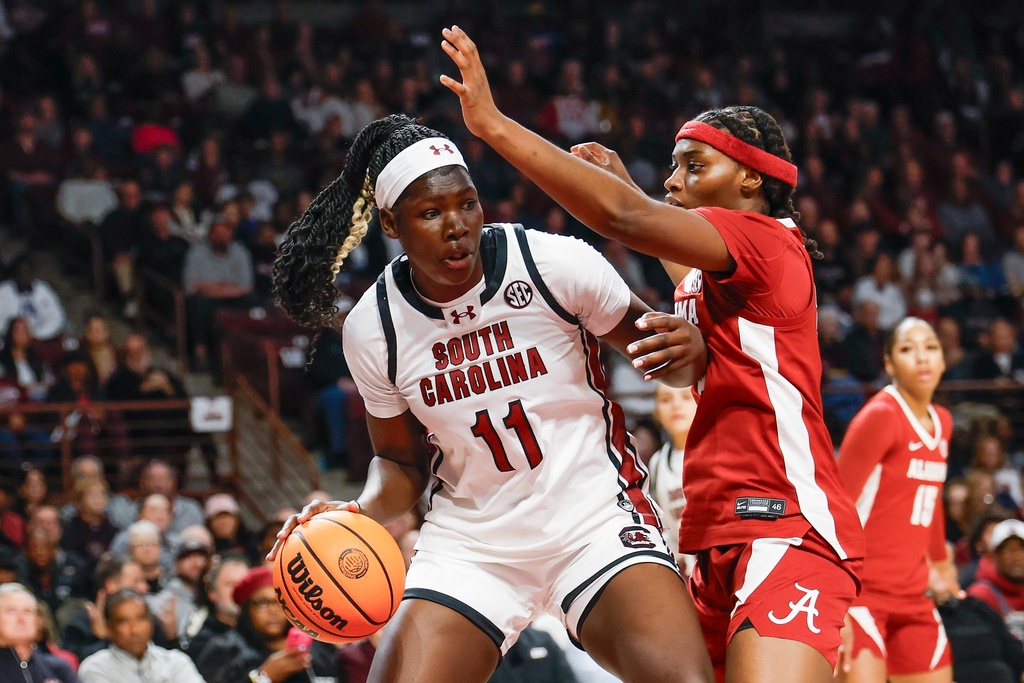 South Carolina center Madina Okot (11) looks to drive against Alabama forward Naomi Jones during the first half of an NCAA college basketball game in Columbia, S.C., Thursday, Jan. 1, 2026. (AP Photo/Nell Redmond)