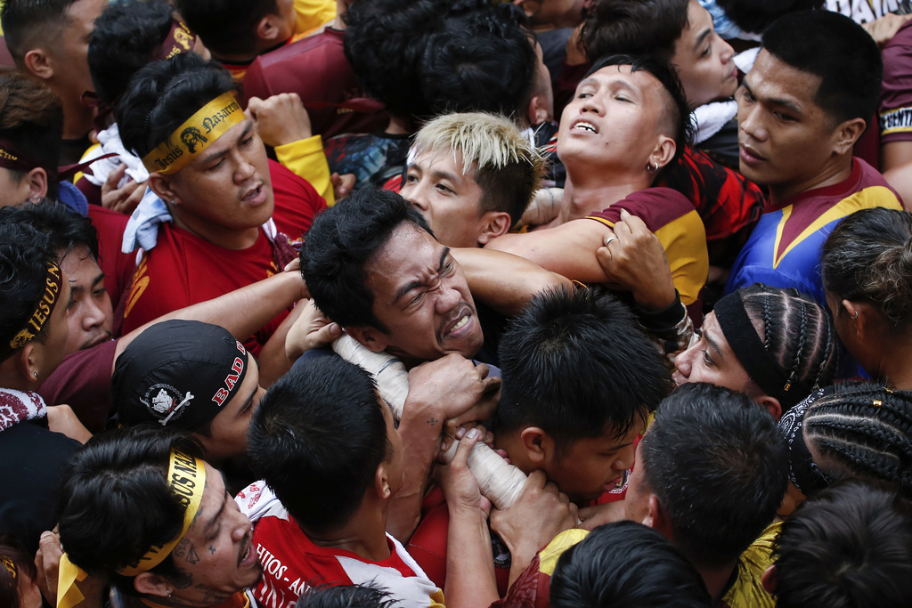 Devotees grab the rope as they pull a glass-covered carriage carrying the image of Jesus Nazareno during its annual procession in Manila, Philippines, Thursday, Jan. 9, 2025. (AP Photo/Basilio Sepe)