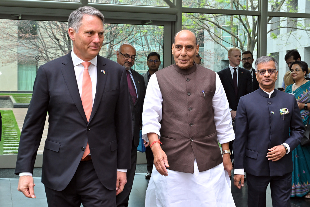 India's Defence Minister Rajnath Singh, center, walks with his Australian counterpart Richard Marles, left, at Parliament House in Canberra, Australia, Thursday, Oct. 9, 2025. (Mick Tsikas/AAP Image via AP)