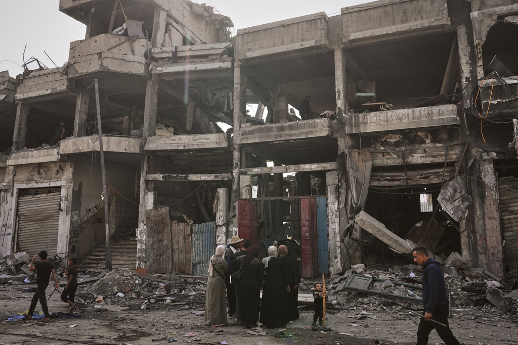 Palestinians inspect the ruins a day after an Israeli strike on a building in Gaza City, Thursday, Nov. 20, 2025. (AP Photo/Jehad Alshrafi)