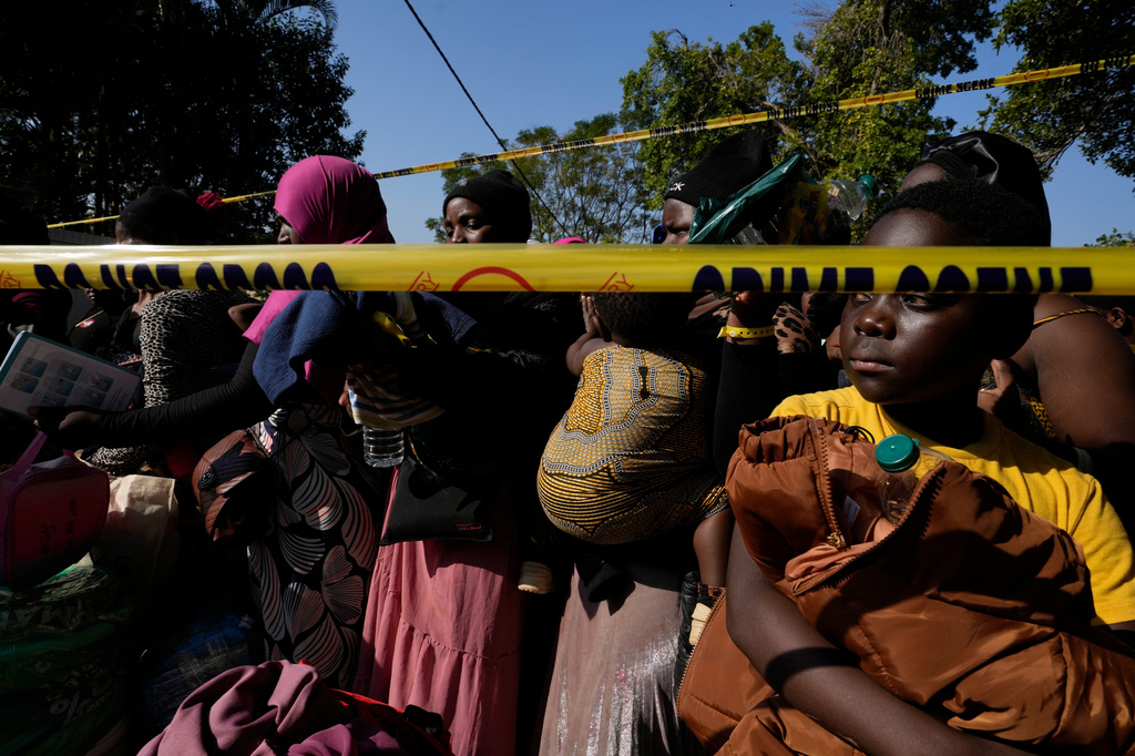 Malawian migrants and children stand in a queue for their deportation at a temporary centre, in Durban, South Africa, Thursday, June 18, 2026. (AP Photo/Themba Hadebe)
